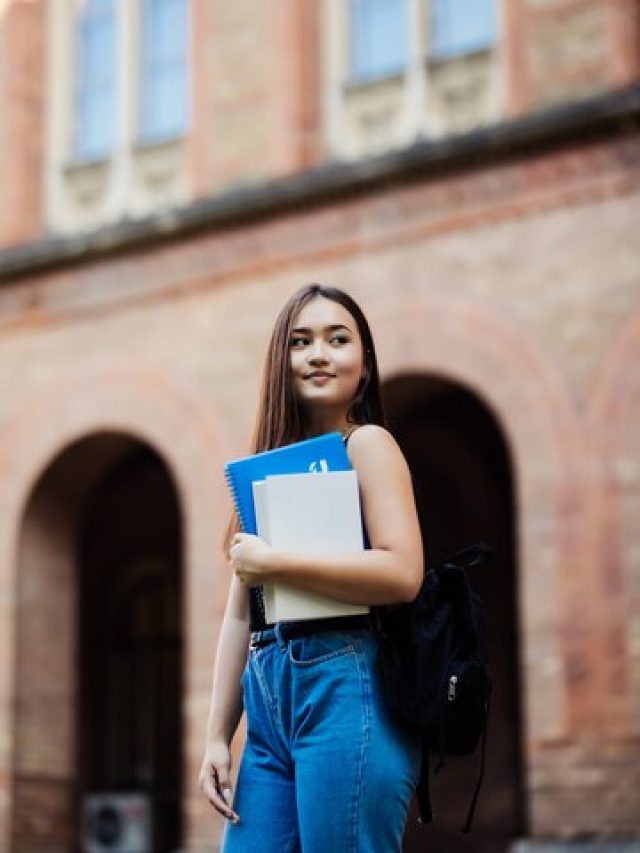 portrait-young-student-holding-book-campus-outdoors_231208-1880